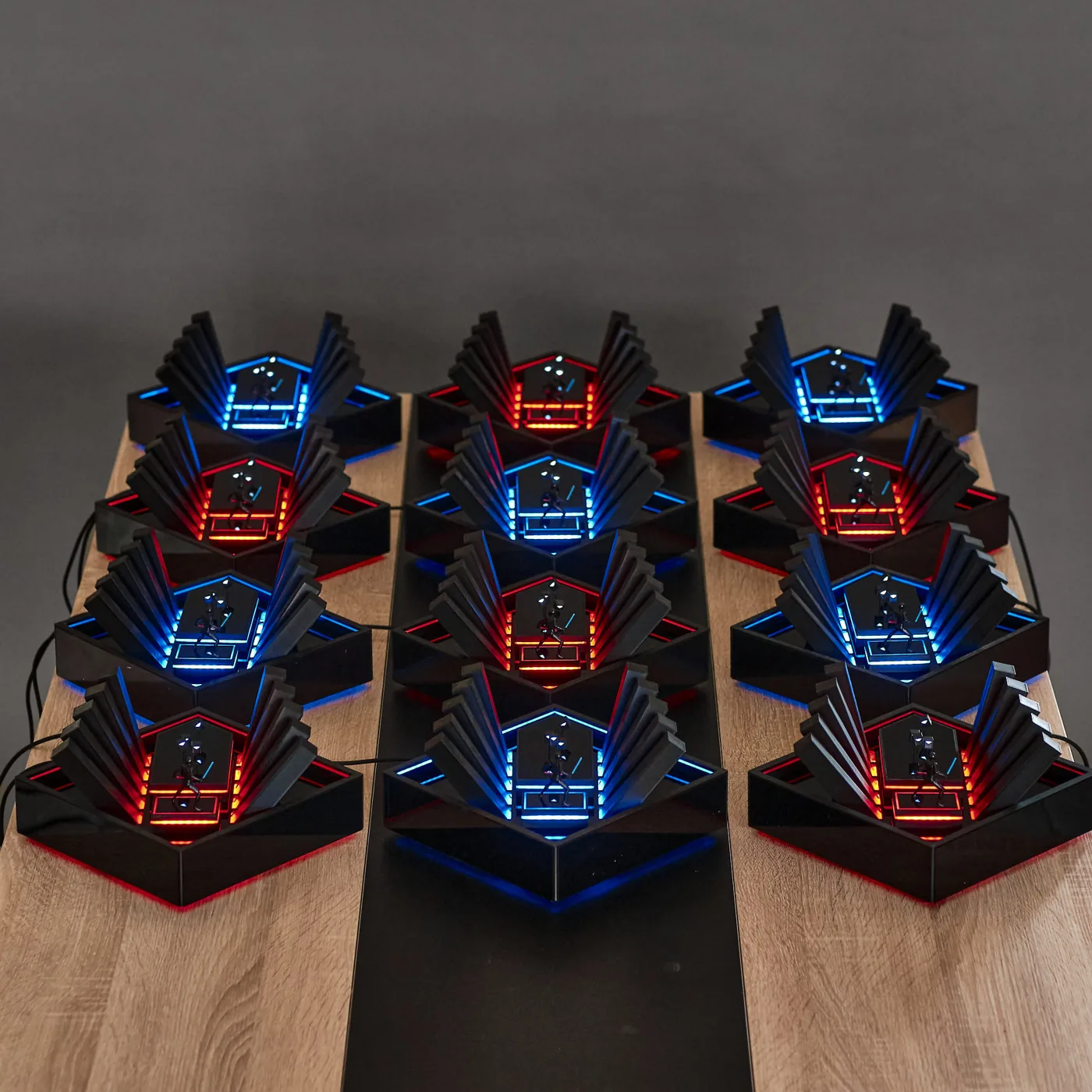 Beat Saber dioramas lined up on a table, lit in red and blue