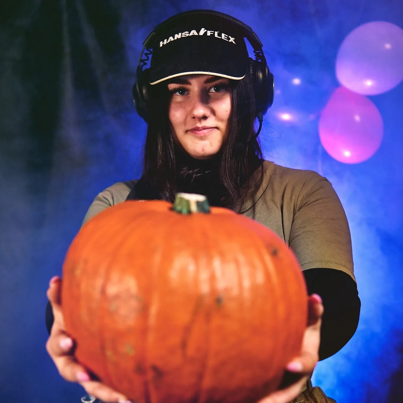 Holding a pumpkin in the workshop
